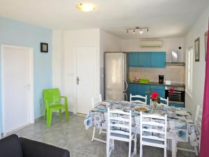 uma cozinha e sala de jantar com mesa e cadeiras em Holiday Home Maslina - TGR616 by Interhome em Voluja