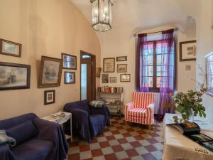 a living room with two couches and a table at Holiday Home Angela - DOL100 by Interhome in Dolcedo