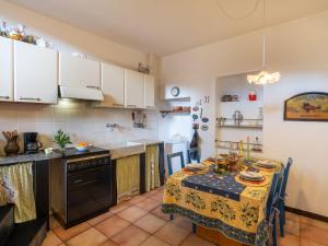a kitchen with a table with a table cloth at Holiday Home Angela - DOL100 by Interhome in Dolcedo