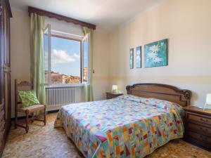 a bedroom with a bed and a large window at Apartment Mare e Monti by Interhome in San Lorenzo al Mare +17 photos