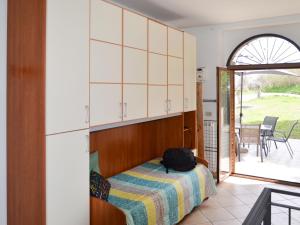 a bedroom with a bed with a backpack on it at Holiday Home Gabriele by Interhome in Picciano +7 photos