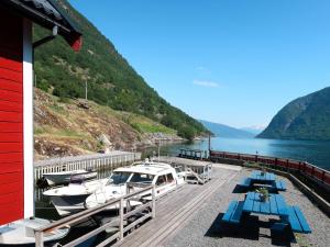 a deck with tables and boats on the water at Holiday Home Jambueggi by Interhome in Arnefjord