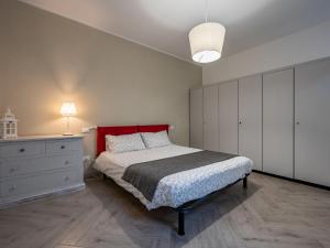 1 dormitorio con 1 cama con cabecero rojo y vestidor en Apartment Stella Blu by Interhome, en Omegna