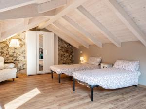 2 camas en una habitación con techos de madera en Apartment Stella Blu by Interhome, en Omegna