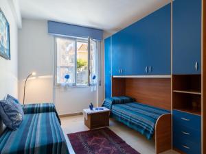 a blue room with a bed and a couch at Apartment Casa Fidalma by Interhome in Costarainera