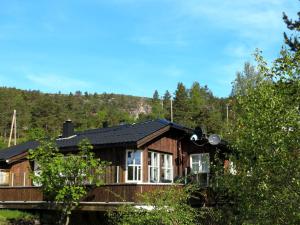 una cabaña de madera en el bosque con árboles en Holiday Home Solfridbu - SOW070 by Interhome en Øyuvstad
