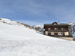 a building sitting on top of a snow covered mountain at Apartment Casa Crapena-1 by Interhome in Livigno