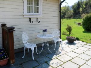 two chairs and a table on a patio at Holiday Home Kvamsvika - FJS560 by Interhome in Kvammen