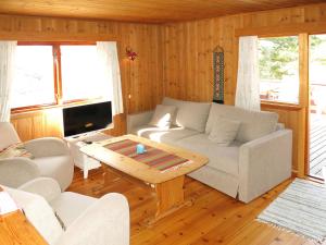 a living room with a couch and a table at Holiday Home Hammaren by Interhome in Kaupanger