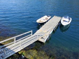 two boats are docked at a dock in the water at Holiday Home Tor - FJS607 by Interhome in Arnefjord