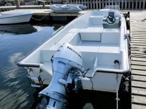 a boat tied to a dock with a machine on it at Holiday Home Kyrkjestein - FJS556 by Interhome in Naustdal i Sunnfjord