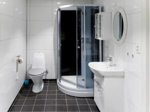 a bathroom with a shower and a toilet and a sink at Holiday Home Kyrkjestein - FJS556 by Interhome in Naustdal i Sunnfjord