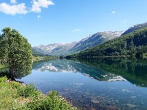 a view of a lake with mountains in the background at Chalet Haukedalspanorama by Interhome in Holsen