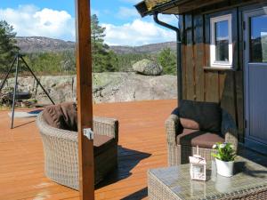 a screened in porch with two chairs and a table at Holiday Home Utsikten - SOW134 by Interhome in Tjaldal