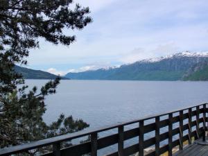 a view of a lake with snow covered mountains at Chalet Eiknes - FJH412 by Interhome in Tjoflot