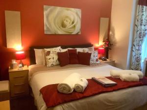 a bedroom with a bed with towels on it at Eden's Rest Bed and Breakfast in St Austell