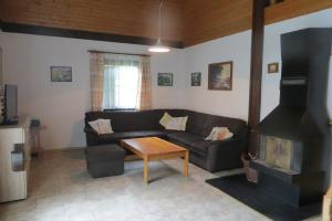 a living room with a couch and a fireplace at Ferienhaus Petra in Regen