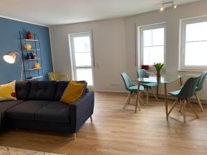 a living room with a couch and a table at Ferienwohnungen Bohner/Ferienwohnung Maria in Meersburg