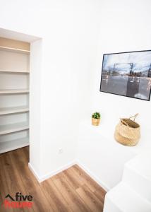 uma sala de estar com televisão na parede em Five House 14B no Porto