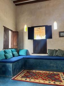 
a living room with a blue couch and a blue rug at Subira House in Lamu
