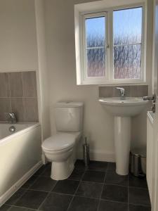 a bathroom with a toilet and a sink at Hill House - 5 Mins Merry Hill - Perfect for Contractors & Families in Brettell Lane