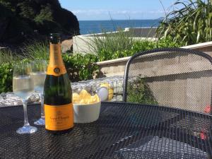 una botella de vino sentada en una mesa con copas de vino en Eddies by the Sea, en Ilfracombe