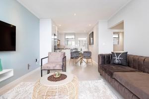 a living room with a couch and a table at Urban Oasis at Apex in Johannesburg