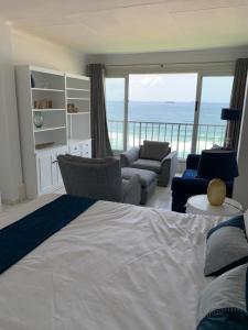 a bedroom with a bed and a view of the ocean at 71 Kyalanga in Durban