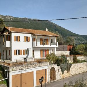 a large white house with a garage at Villa Syvros in Sívros