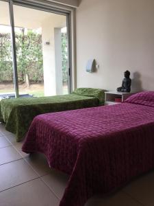 Tempat tidur dalam kamar di El Oásis Playa