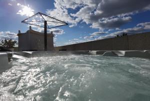 a hot tub with water in it with the sky at Castelo Hotel in Chaves