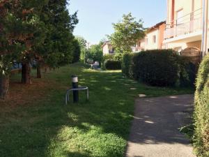 a park with a trash can in the grass at Helvétia in Thonon-les-Bains