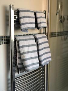 a group of towels on a towel rack in a bathroom at Squirrel house B&B in High Wycombe