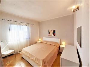 a small bedroom with a bed and a window at Baia de Bahas - Apartments & Resort in Santa Marinella