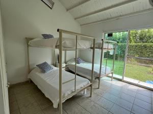 two bunk beds in a room with a window at Casa en Girardot in Ricaurte