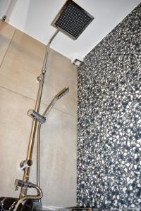 un soffione doccia in un bagno con parete di Saxon's Apartment a Chania