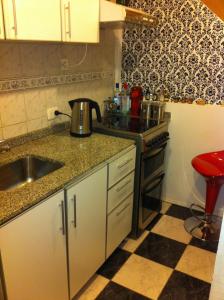 a small kitchen with a sink and a stove at Hipolito Argentina in Buenos Aires