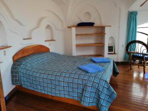 Cama o camas de una habitación en Hostal Las Olas