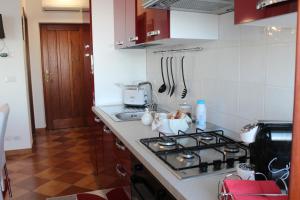 a kitchen with a stove and a counter top at Villa Sofia in Taormina