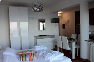 a room with a bed and a table and a kitchen at Villa Sofia in Taormina
