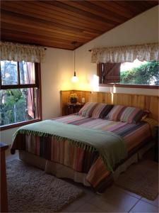 Cama ou camas em um quarto em Chalé Aconchegante
