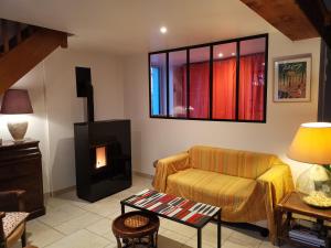 a living room with a couch and a fireplace at Le moulin de La Retardière in Orvault