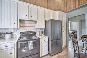 a kitchen with a stainless steel stove and refrigerator at Cozy Livingston House with Fenced Yard and Patio! in Livingston
