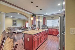 a kitchen with red cabinets and a living room at Manteca Home with Gated Yard about 2 Mi to Downtown in Manteca