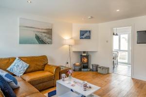 a living room with a couch and a table at Shrimper's Cottage in Wadebridge