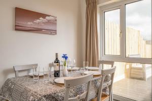 a dining room with a table and chairs and a window at Shrimper's Cottage in Wadebridge