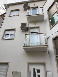 ein weißes Gebäude mit Balkon in der Unterkunft CASA MONTEVIDEU in Mirandela