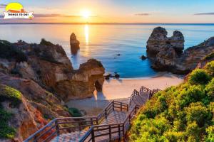 a staircase leading to a beach with rocks in the ocean at #073 V3 Casa Verde by Home Holidays in Albufeira