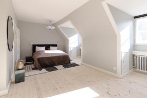 a white bedroom with a bed in a attic at Luxury Apartment w Privat Rooftop Terrace - CPH C in Copenhagen