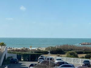 a parking lot with a view of the ocean at Studio front de mer 'Le Soleillan' in La Grande Motte